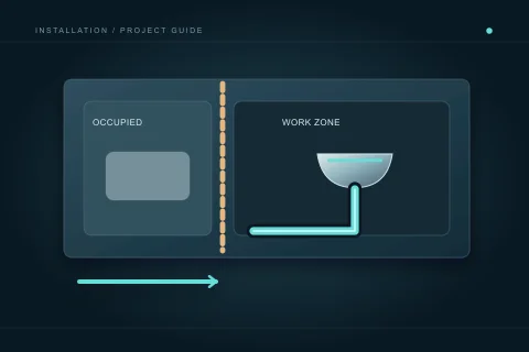 An occupied room is separated from a plumbing work zone, with a clear staged-access route below.